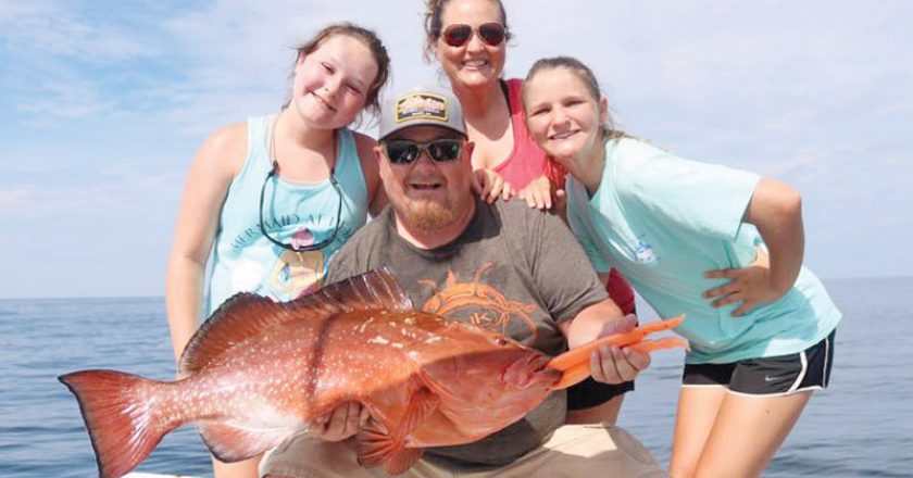 Blake family with a nice red grouper on the Adrenaline boat.
