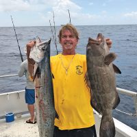 Greg with a nice kingfish and grouper caught aboard Catch My Drift.