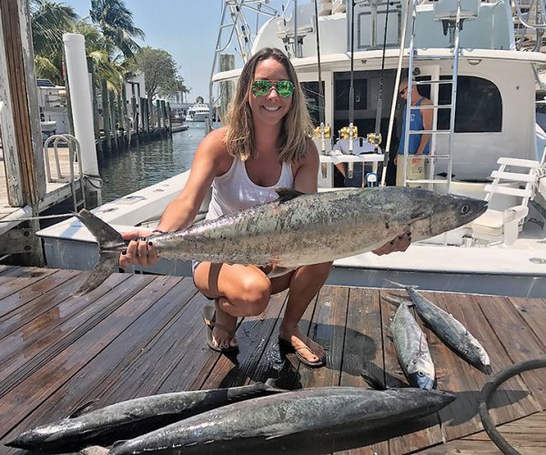 Ashlee with some big kingfish caught on a Fishing Headquarters charter.