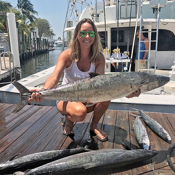 Ashlee with some big kingfish caught on a Fishing Headquarters charter.