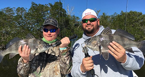 Charlie “the fish slayer” and his dad Chuck, with a beautiful pair of black drum.