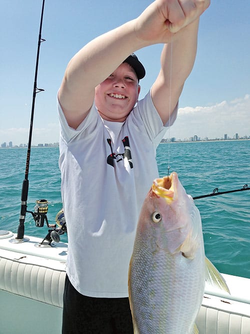 Happy camper with a flag yellowtail snapper.