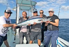 Smiles all around with a nice wahoo caught with Nomad Fishing Charters.