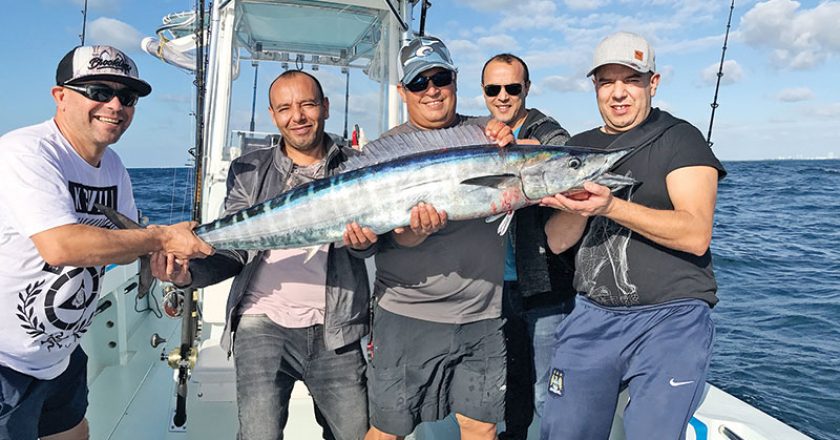 Smiles all around with a nice wahoo caught with Nomad Fishing Charters.