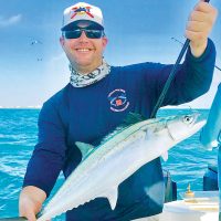 Happy angler with a Spanish mackerel caught aboard Bouncer’s Dusky 33.