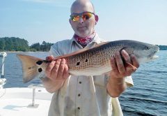 Matt Webb with a nice slot sized redfish fishing with Capt. Jason.