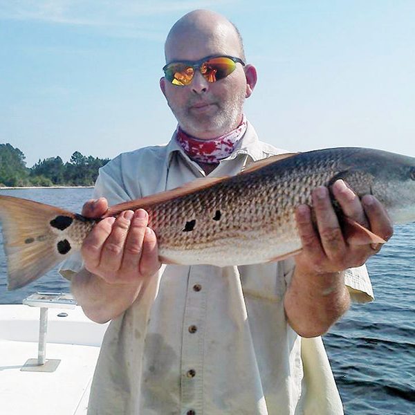 Matt Webb with a nice slot sized redfish fishing with Capt. Jason.