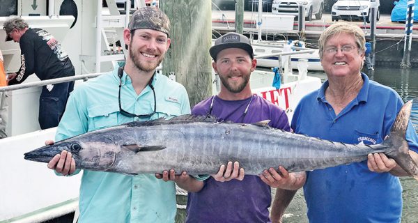 Capt Paul and Josh with a big wahoo caught with Fishing Headquarters.
