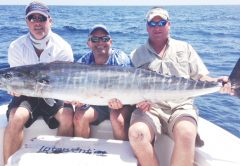 Jamie Jordan (left), Aaron Fahnestock (center), and John Shelton caught this beautiful wahoo on 50lb fluorocarbon.