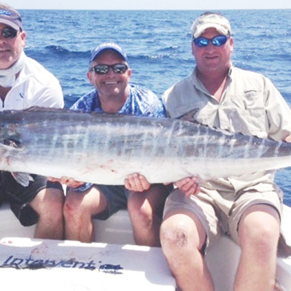 Jamie Jordan (left), Aaron Fahnestock (center), and John Shelton caught this beautiful wahoo on 50lb fluorocarbon.