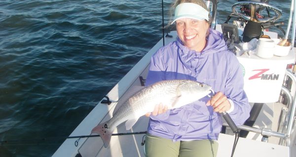 Kim catches a fine example of a Mosquito Lagoon redfish on a recent trip with Capt. Mark Wright.