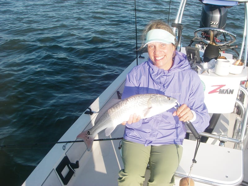Kim catches a fine example of a Mosquito Lagoon redfish on a recent trip with Capt. Mark Wright.
