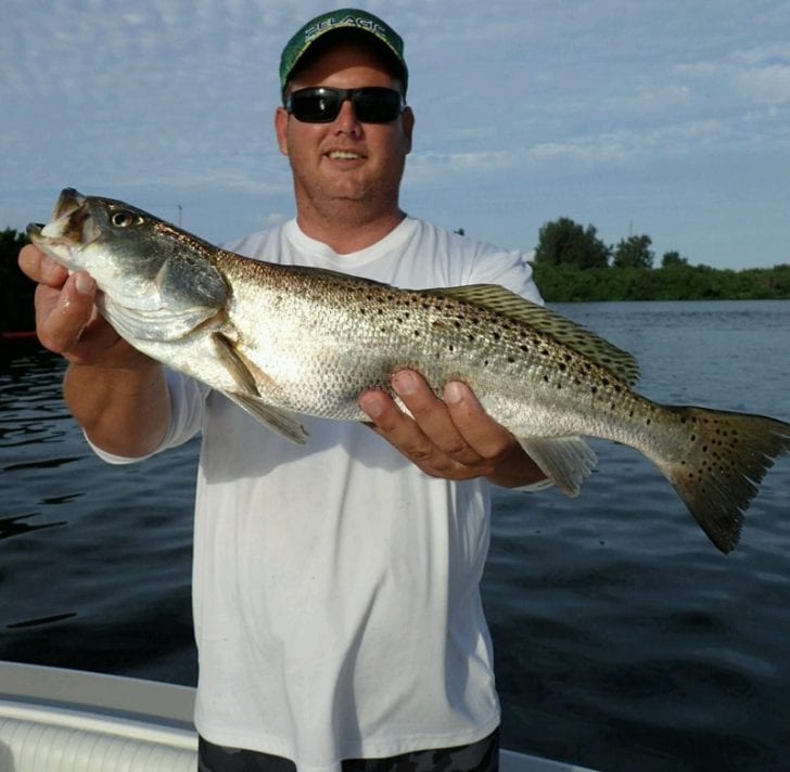 Mike Barker, owner of The Chum Buddy, showing off his first ever speckled trout.