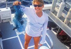 Jamie Cruce holds up tangled fishing line divers removed from a reef.