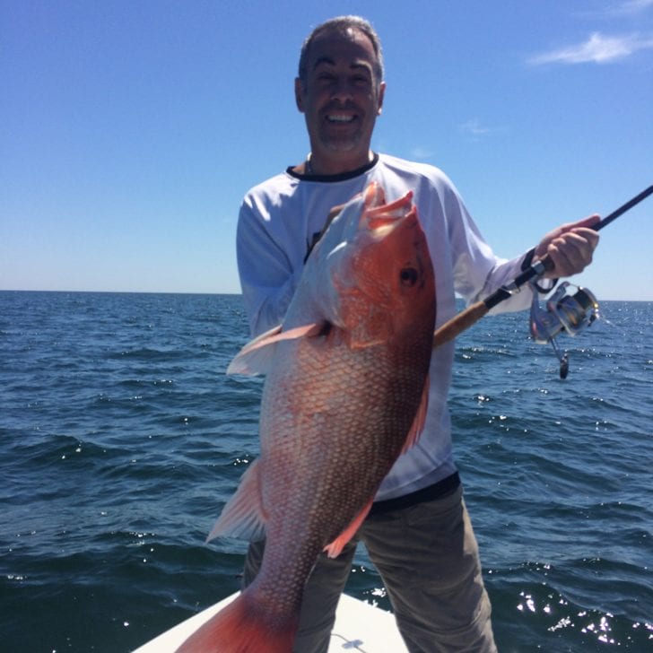 Paul Caruso shows off a beautiful Red Snapper caught off of Orange Beach.