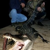 David Meredith (left) and Josh Korel (right) show off a gator they caught on the Escambia River.