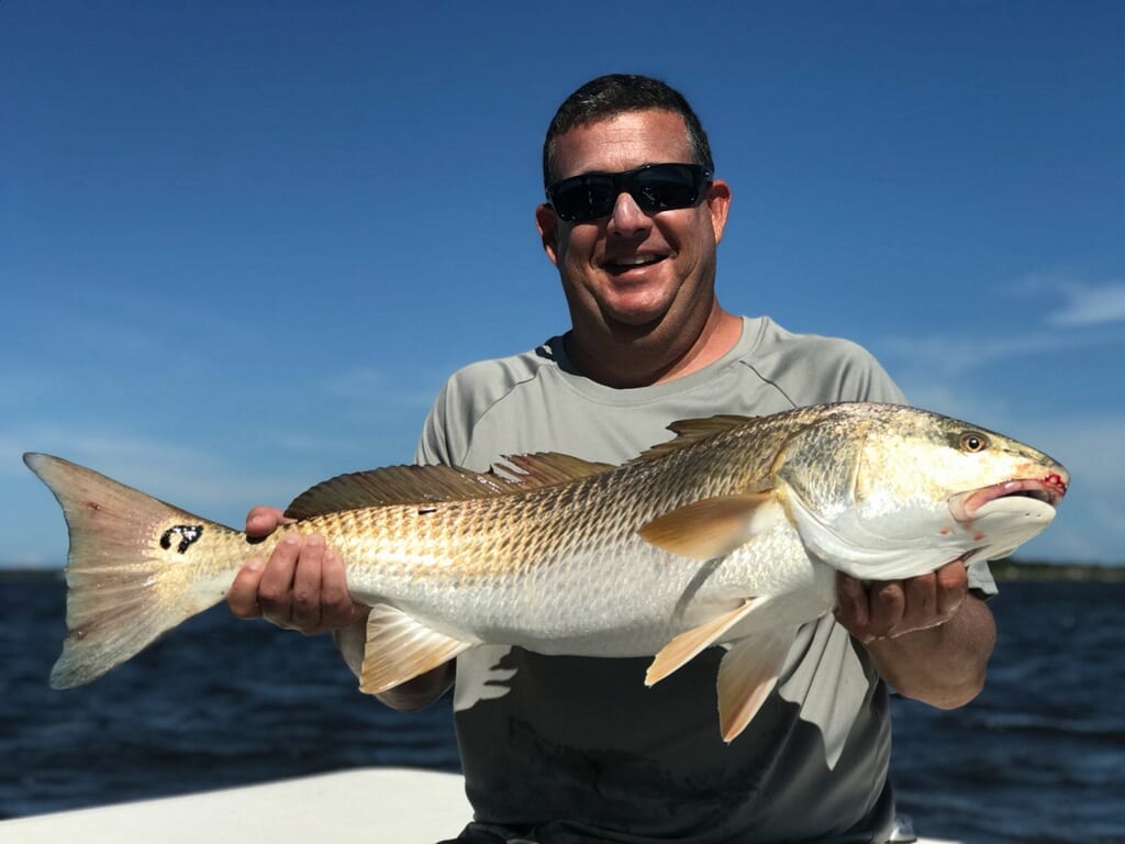 Brandon with a slob redfish | Coastal Angler & The Angler Magazine