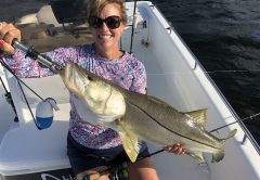 Jackie with a snook caught on a DOA C.A.L. 3” shad tail.