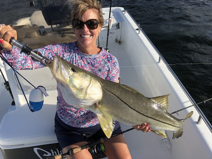 Jackie with a snook caught on a DOA C.A.L. 3” shad tail.