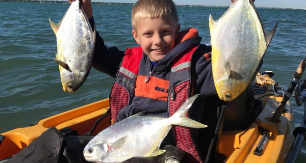 Braden Nelli with his first couple of pompano.