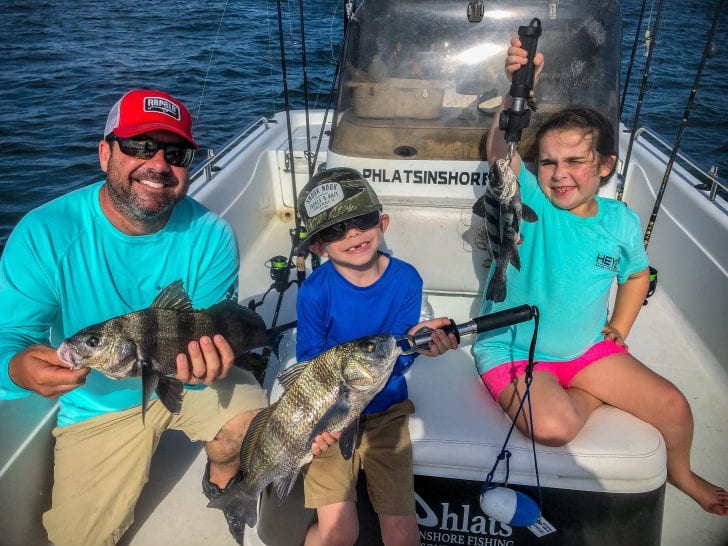 Ryan, Ryker and Ocean holding up black drum.