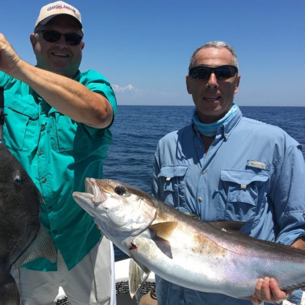 Paul Caruso and Chappy show off their catch this past season while fishing with Underdog Charters.