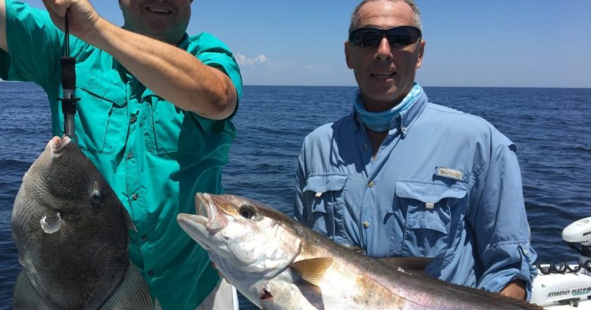 Paul Caruso and Chappy show off their catch this past season while fishing with Underdog Charters.