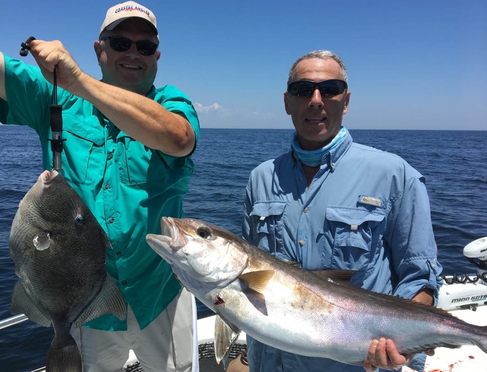 Paul Caruso and Chappy show off their catch this past season while fishing with Underdog Charters.