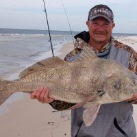 Bryan Rhyde shows off a big drum he caught at Fort Morgan.