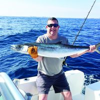 man on boat with kingfish
