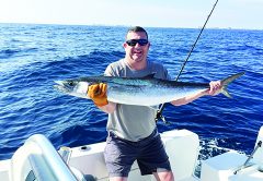 man on boat with kingfish