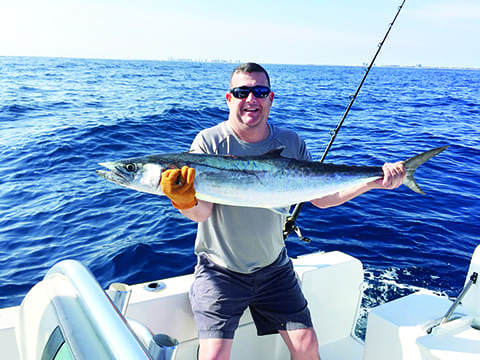 man on boat with kingfish
