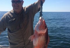 Chappy catching amazing red snapper while fishing with Underdog Charters.