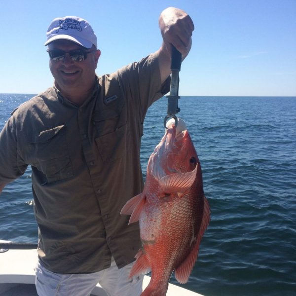 Chappy catching amazing red snapper while fishing with Underdog Charters.