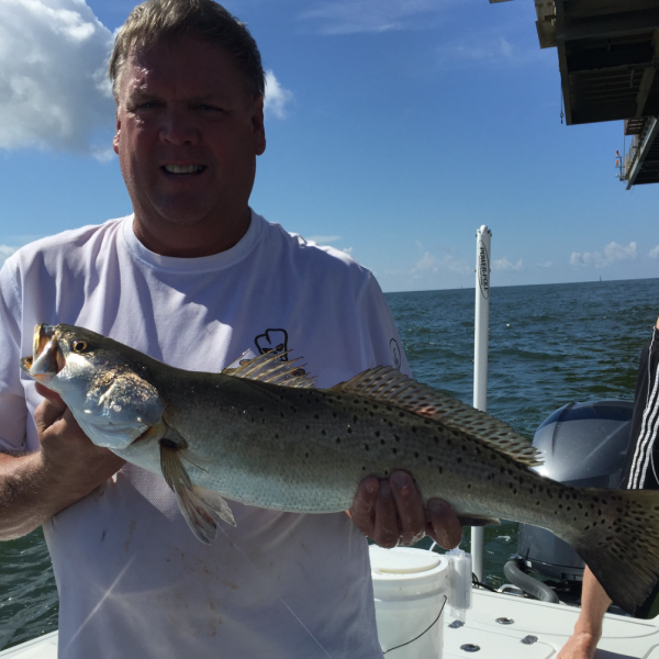 Capt. Charlie Grey of Grey Gulf Charters shows off a nice Speckled Trout fishing off of Dauphin Island.