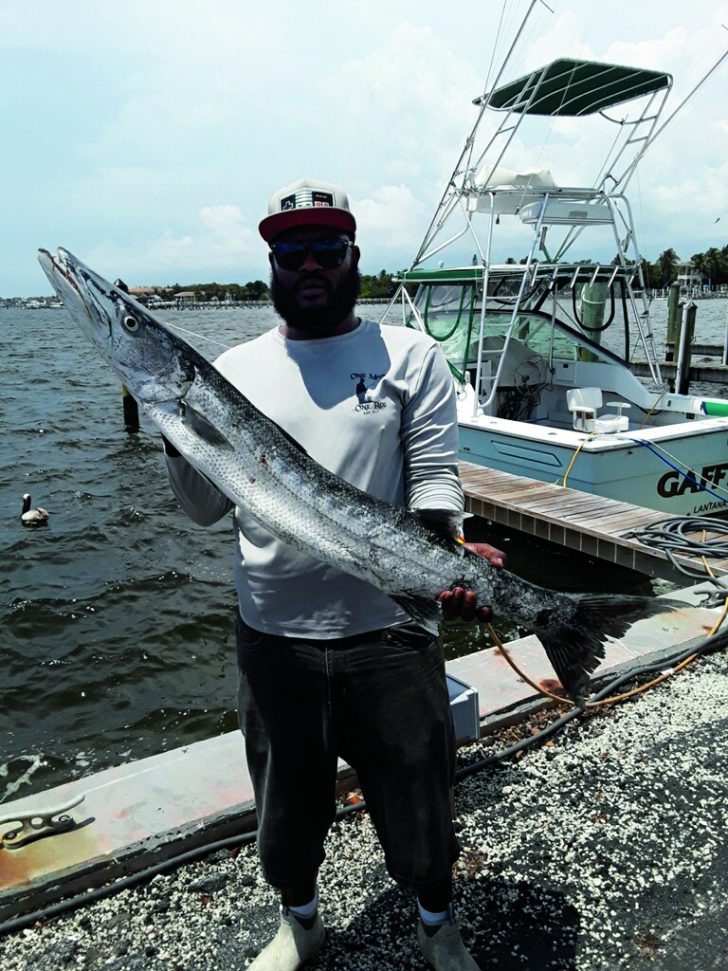 Kevin “One Man One Rod” Woods with a barracuda on the Bar Jack out of  Lantana. - Coastal Angler & The Angler Magazine