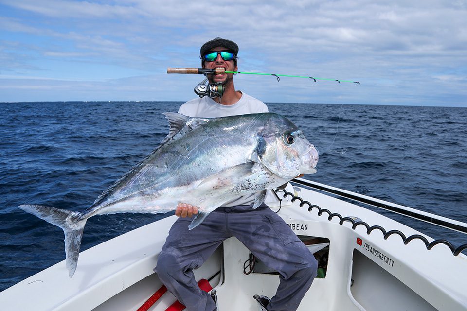 Fisherman with a fishing rod in a boat. Catching a big fish