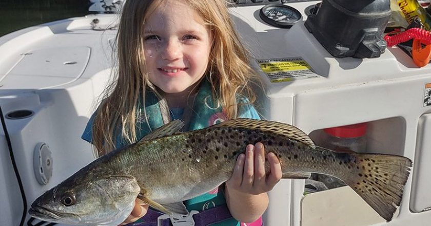 Little 3-year-old Gracie caught a nice 18" spotted seatrout in chilly water using a Slayer Inc. paddle tail fishing with her dad, Captain Shane Trottier of Whatever Turns U On Fishing Charters.