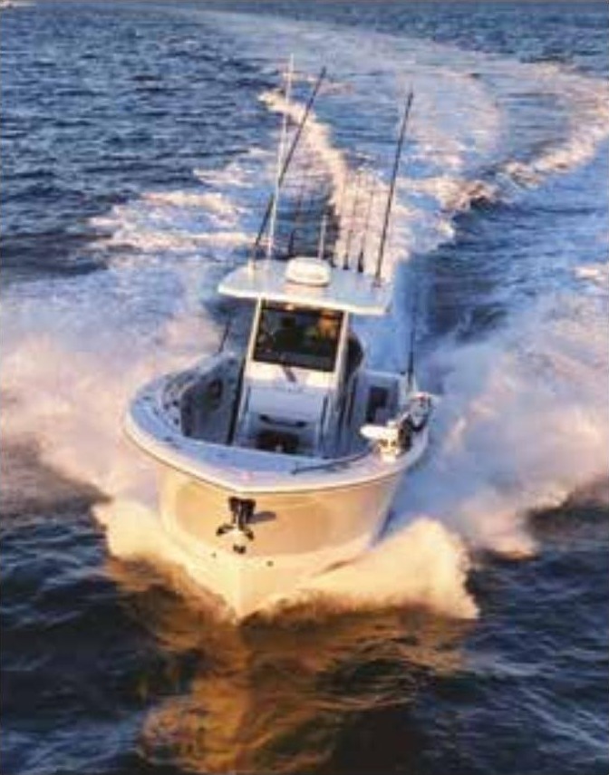 A center console fishing boat with outriggers running fast across the open ocean, leaving a wide white wake