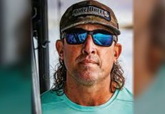 Capt. Daniel Levesque of Rare Breed Charters in a Rare Breed cap, blue mirrored sunglasses and a teal Rare Breed shirt