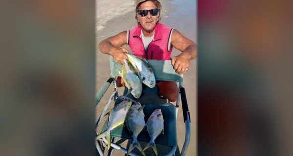 Marco Pompano on the beach with a cart full of pompano