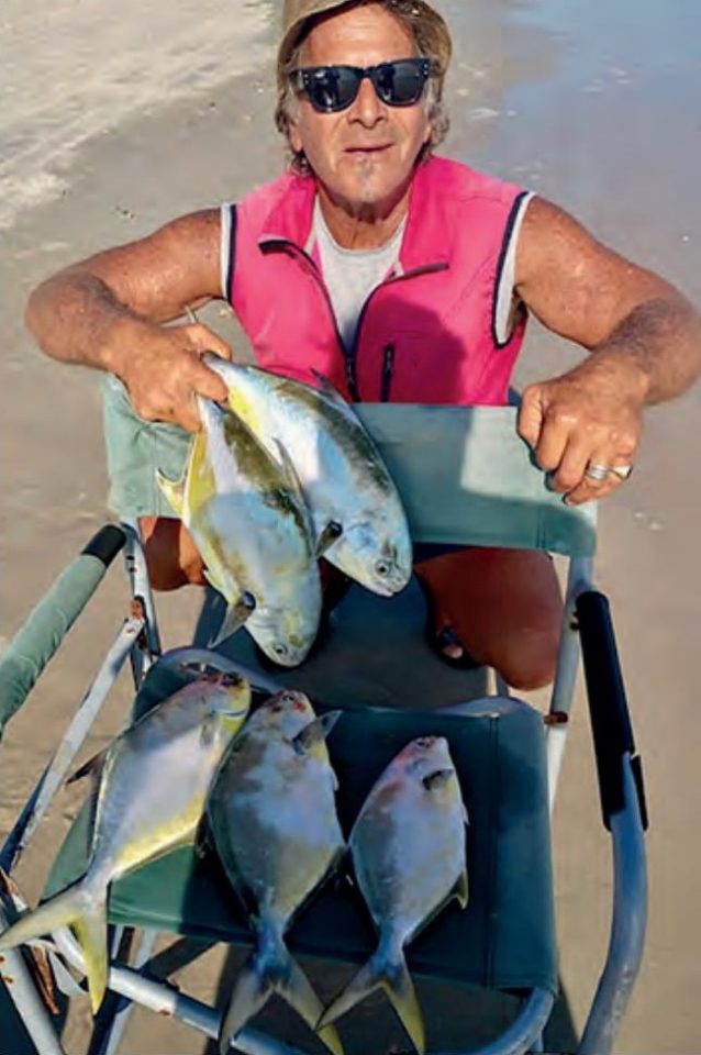 Marco Pompano on the beach with a cart full of pompano