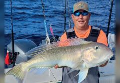 Capt. Tim Russell of Captain Daddy's Fishing Charters holding a golden tilefish on a boat