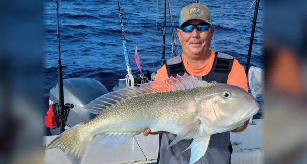 Capt. Tim Russell of Captain Daddy's Fishing Charters holding a golden tilefish on a boat