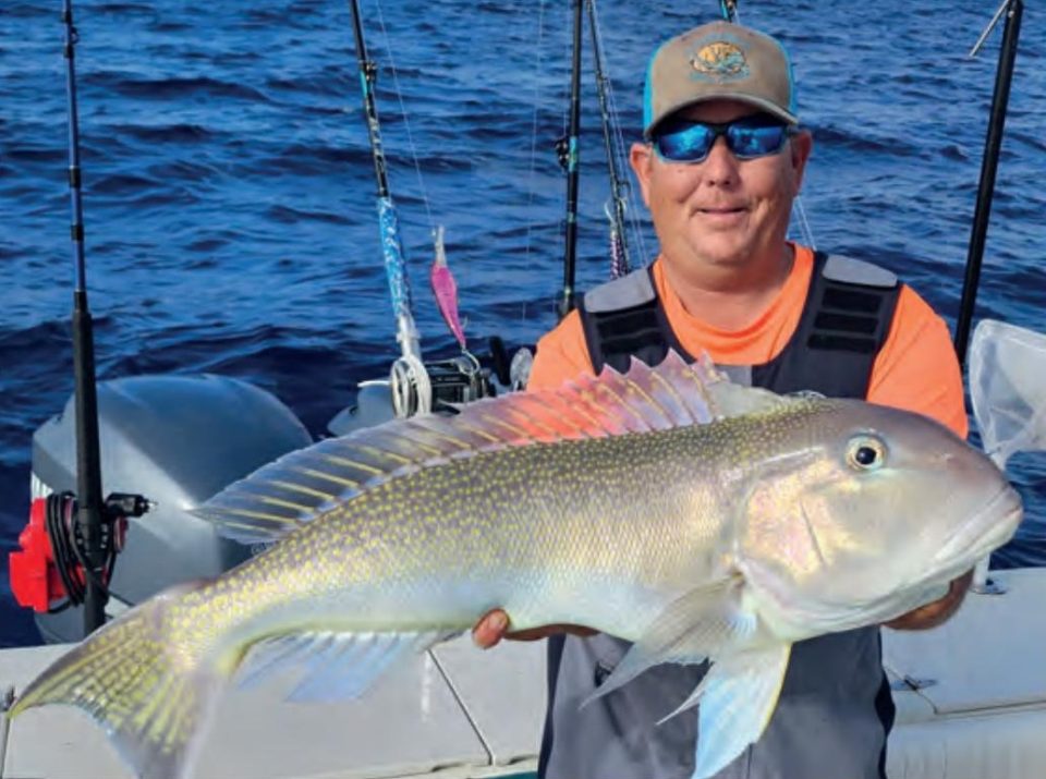 Capt. Tim Russell of Captain Daddy's Fishing Charters holding a golden tilefish on a boat