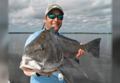 Capt. Bucky Goldman holding a black drum he caught sight casting a live shrimp
