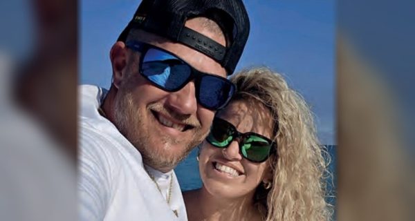 Chris Mansfield of Reel Healin Outdoors smiling in a selfie with a woman by the water