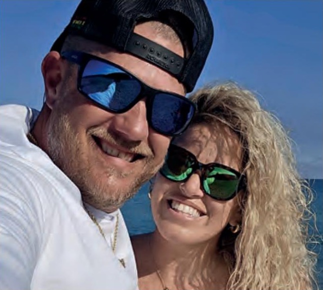 Chris Mansfield of Reel Healin Outdoors smiling in a selfie with a woman by the water