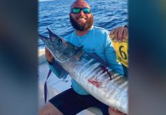 Capt. Nicholas Siciliano of Beast Coast Fishing Charters holding a wahoo on a boat