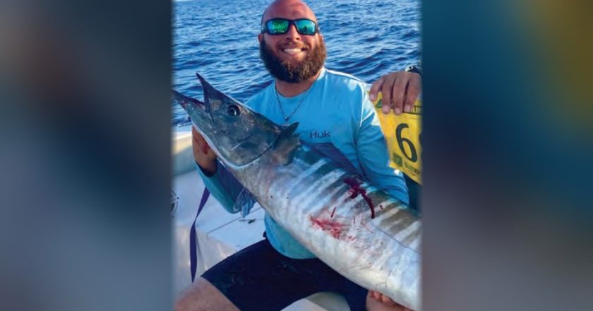 Capt. Nicholas Siciliano of Beast Coast Fishing Charters holding a wahoo on a boat